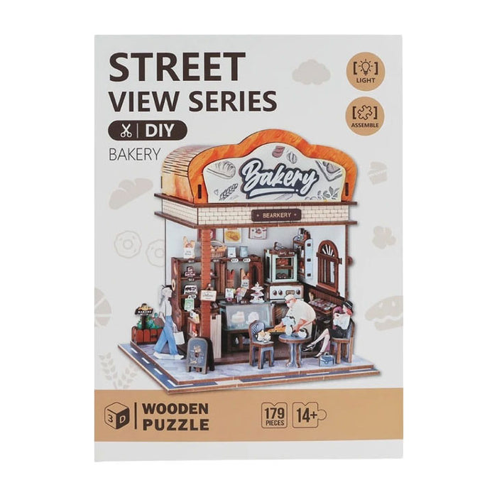 Product packaging for a Street View Series 3D wooden bakery puzzle with 179 pieces and an LED light feature.