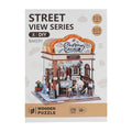 Product packaging for a Street View Series 3D wooden bakery puzzle with 179 pieces and an LED light feature.