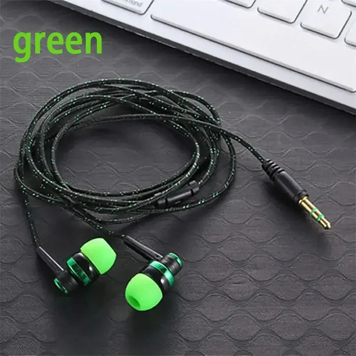 Green 3.5mm Wired In-ear Stereo Bass Earphone Nylon Weave Cable with active noise-cancellation lying on a desk next to a keyboard.