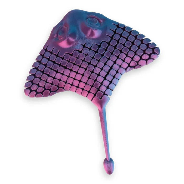Iridescent purple and blue 3D printed stingray toy with articulated segmented wings and a long tail.