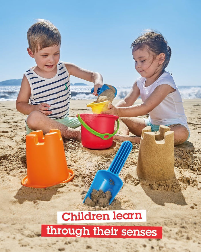Two kids play on a beach with a red bucket, orange castle mold, and blue shovel. Text: Children learn through their senses.
