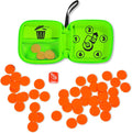 Open neon green travel case with orange game chips and a red die scattered on a white surface.