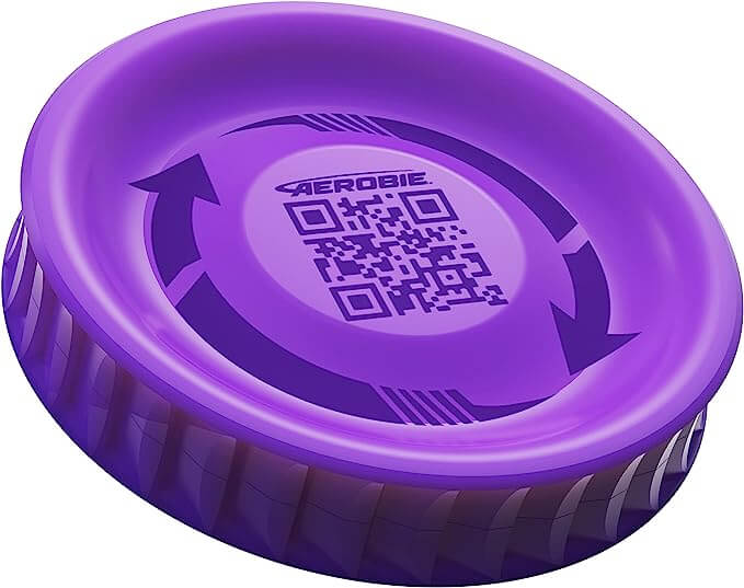 Small purple flying disc with thick ridged edges, central QR code, and Aerobie logo surrounded by curved arrows.