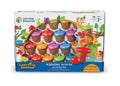 Boxed toy set of colorful plastic acorns with lettered bases and vibrant caps shown through a clear window display.