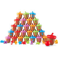 A pyramid of colorful toy acorns with uppercase letters and small matching toy figurines on a white background.