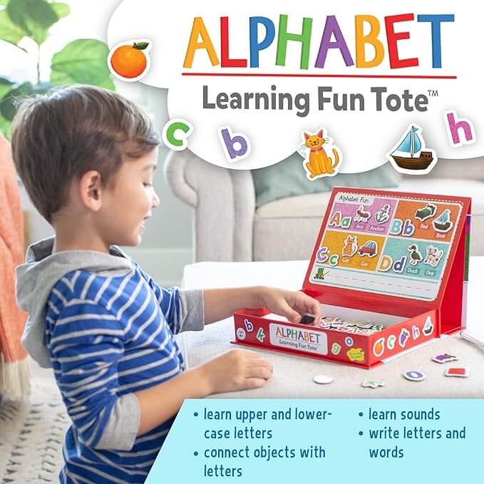 Young boy plays with a red magnetic alphabet learning toy case featuring letter and picture magnet tiles.