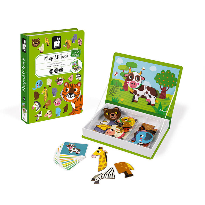 Green book-shaped magnetic toy set with animal magnets, puzzle cards, and a cow scene on a landscape background.