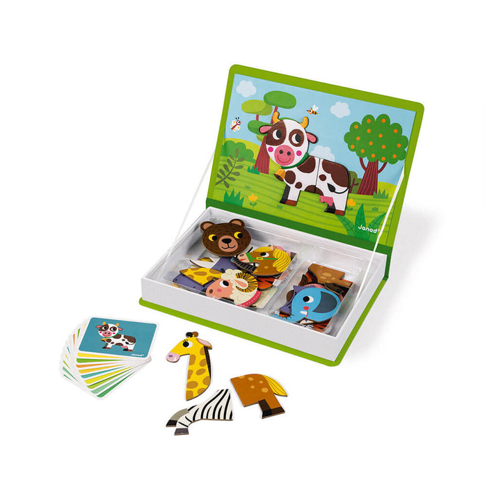 Open book-shaped magnetic puzzle box with animal pieces, reference cards, and a cow scene on the inside lid.