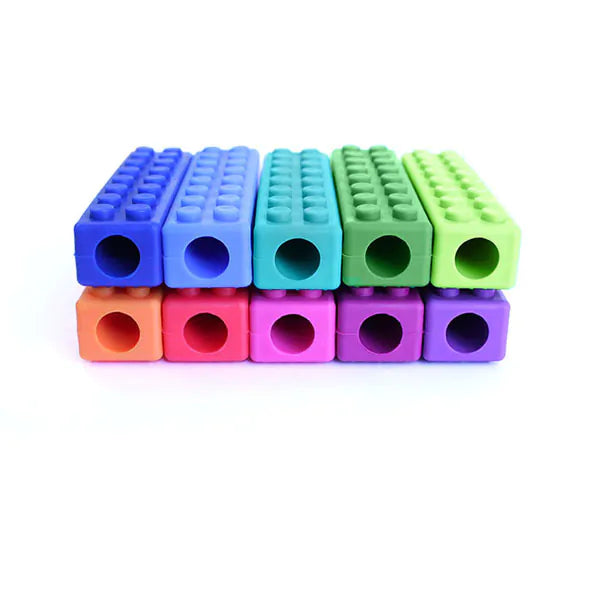 Ten colorful, rectangular pencil toppers with brick-style studs and hollow ends, arranged in two stacked rows.