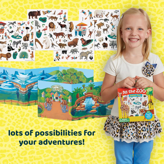 Child holding a zoo sticker book set with reusable animal stickers and two colorful fold-out play scenes.
