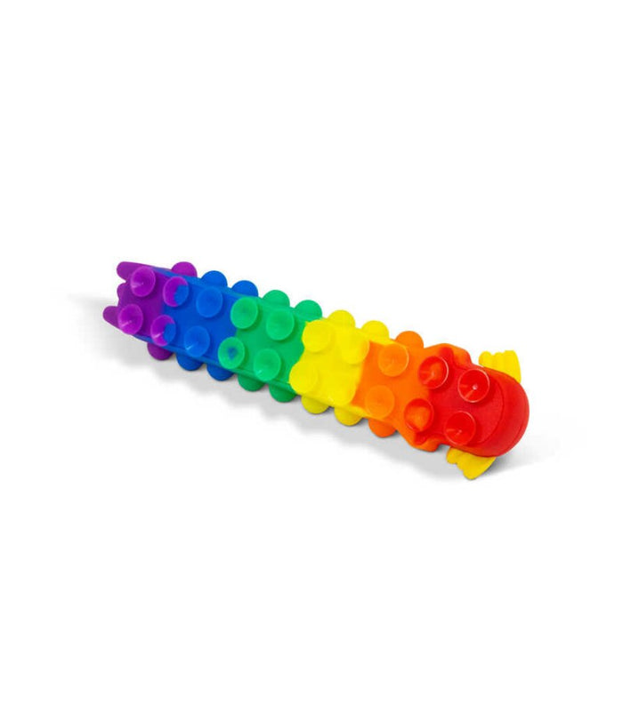 Rainbow-colored segmented axolotl toy covered in small suction cups, lying on a white surface.