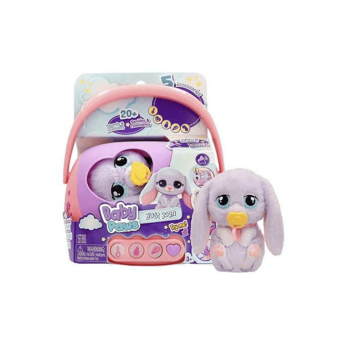 Plush purple bunny with big blue eyes and yellow pacifier next to its pink and purple toy carrier packaging.