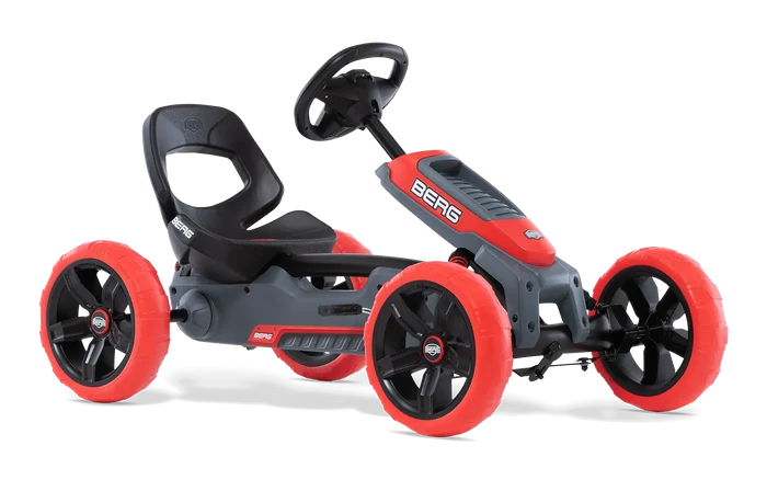 Red and grey pedal go-kart with four chunky red wheels, a black bucket seat, and sport steering wheel.