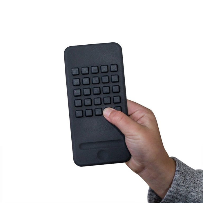 Black rubber phone-shaped fidget toy with tactile square buttons held in a hand against a white background.