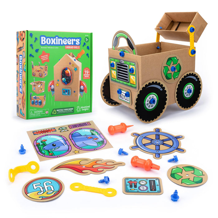 Boxineers kit with green box, assembled cardboard truck, blue plastic screws, orange tools, and colorful cutouts.