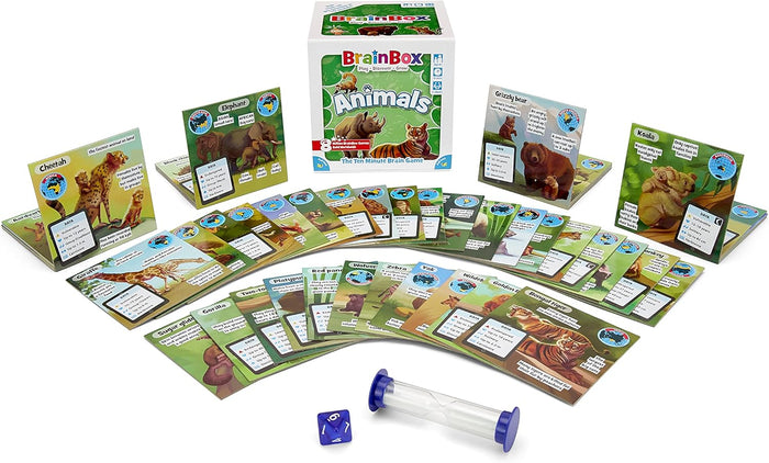BrainBox Animals game featuring fanned-out animal fact cards, a white square box, a blue die, and a sand timer.