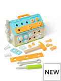 House-shaped wooden toolbox toy with blue roof, hammer, screwdriver, wrench, and colorful building accessories.