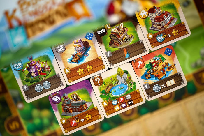 Square game cards featuring colorful illustrations of bunny-themed buildings, golden stars, and resource icons.