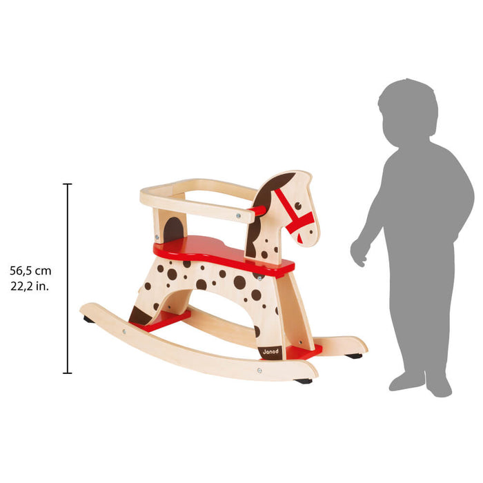 Wooden spotted rocking horse with a red seat, safety rail, and smiling face, next to a child silhouette for scale.