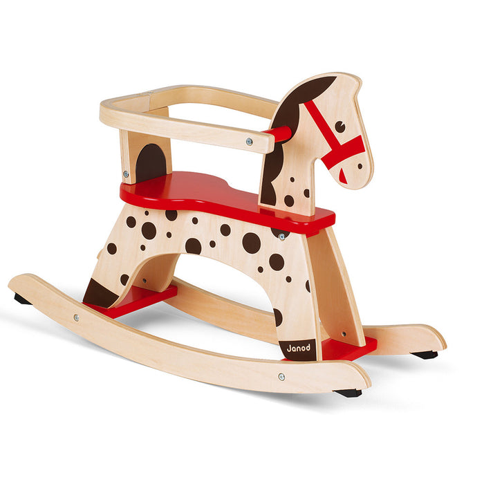 Natural wood rocking horse with red seat, protective rail, and brown spots on curved base rockers.