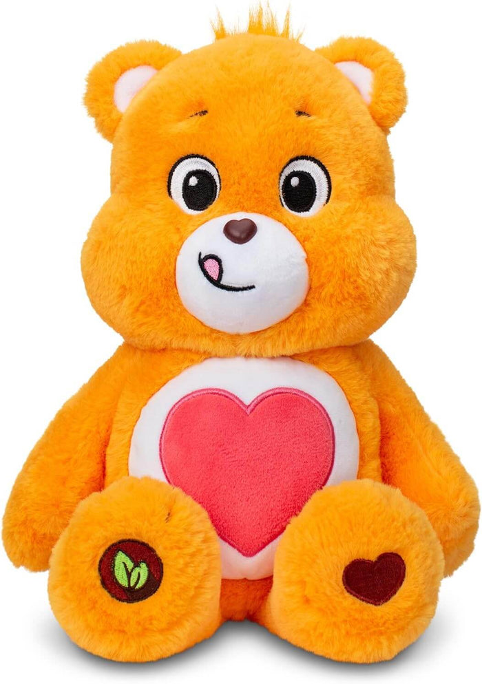 Sitting orange plush bear with a large red heart on its white belly, white muzzle, and green heart paw badge.