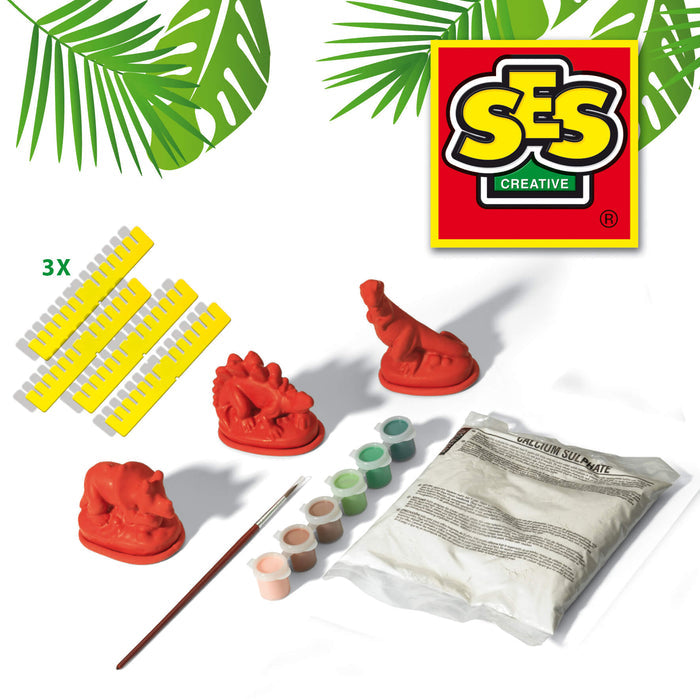 Dinosaur casting kit with 3 red models, yellow plastic molds, paint pots, a brush, and a bag of calcium sulphate.