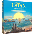 Square blue Catan Seafarers box with a vibrant sunset scene featuring sailboats and figures on a wooden dock.