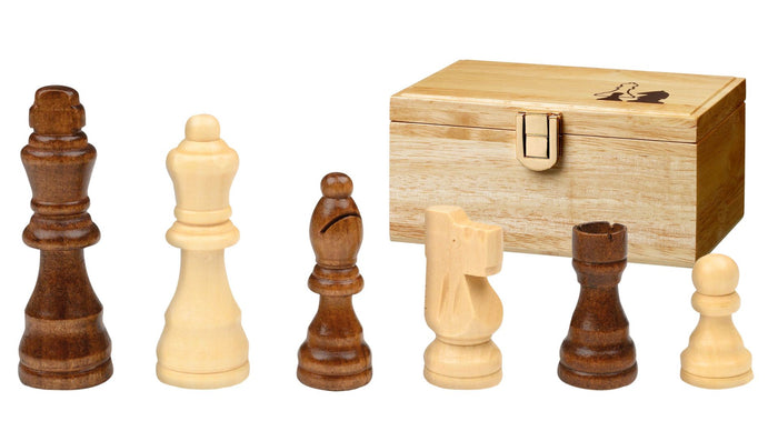 Six light and dark wood chess pieces in front of a light wood storage box with a gold latch.