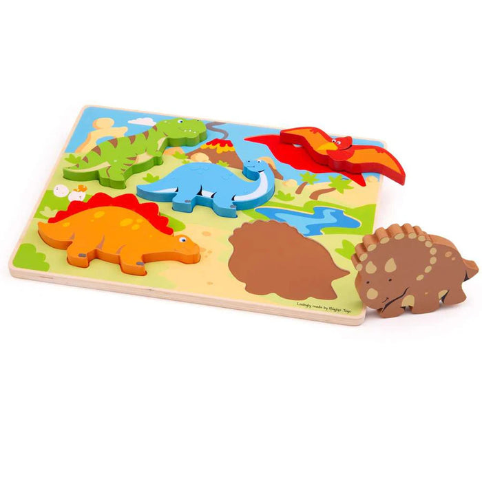 Wooden puzzle with chunky dinosaur pieces including a green T-Rex and orange Stegosaurus on a colorful prehistoric board.