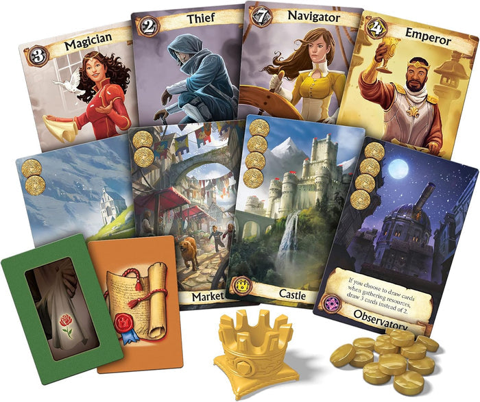 Fantasy cards depicting characters and buildings, a yellow plastic crown token, and a pile of gold coins.