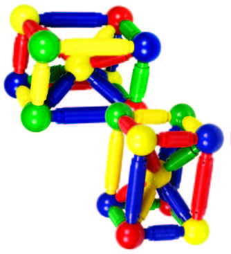 Two 3D geometric structures built with oversized red, yellow, green, and blue magnetic rods and ball connectors.