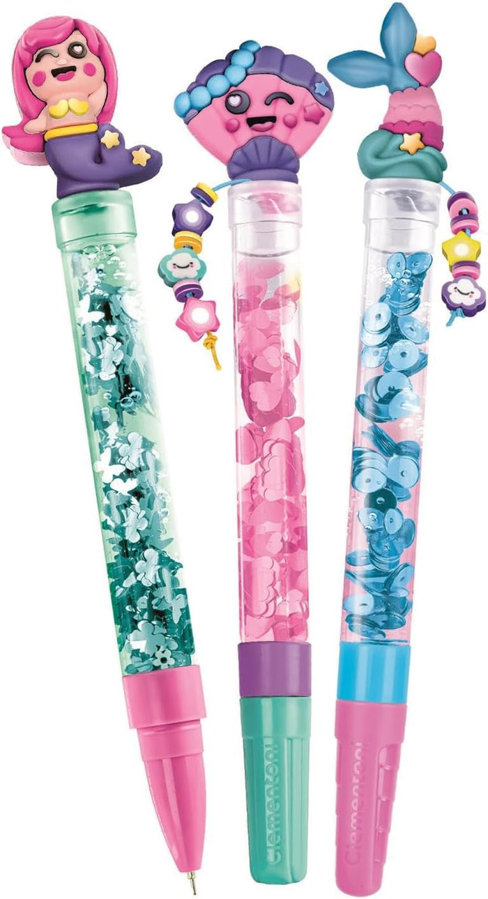 Three colorful pens with mermaid, shell, and tail toppers, liquid confetti barrels, and decorative beaded charms.