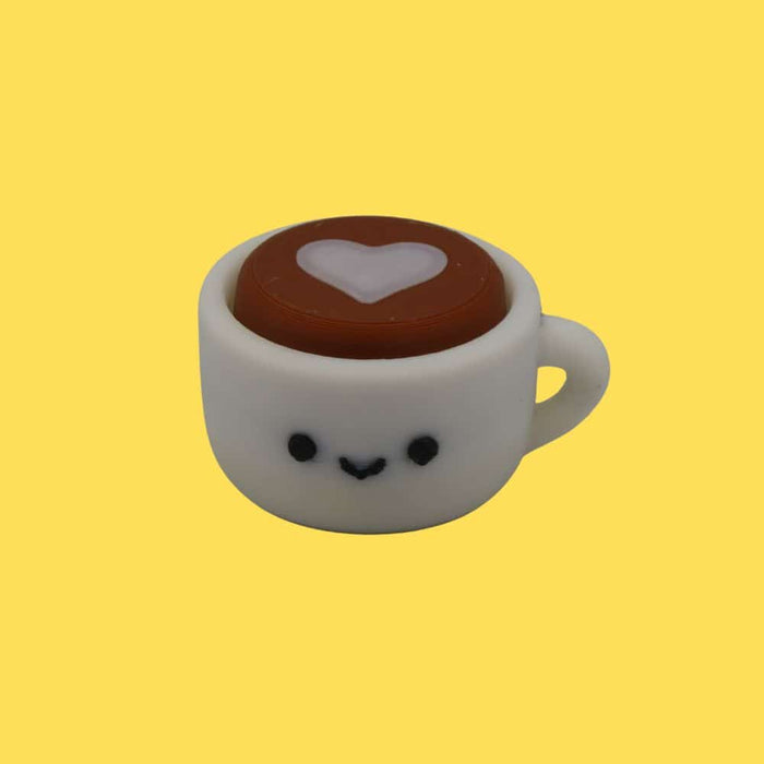 White 3D-printed coffee cup with a smiley face and heart latte art, centered on a solid yellow background.