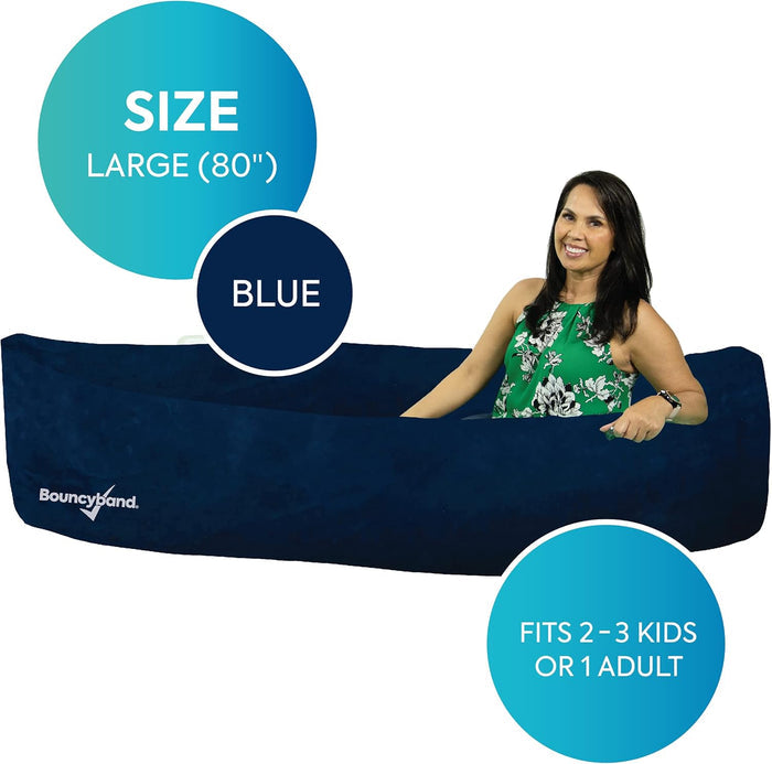 Woman sitting in a large 80-inch dark blue inflatable sensory peapod seat with a soft, boat-like shape.