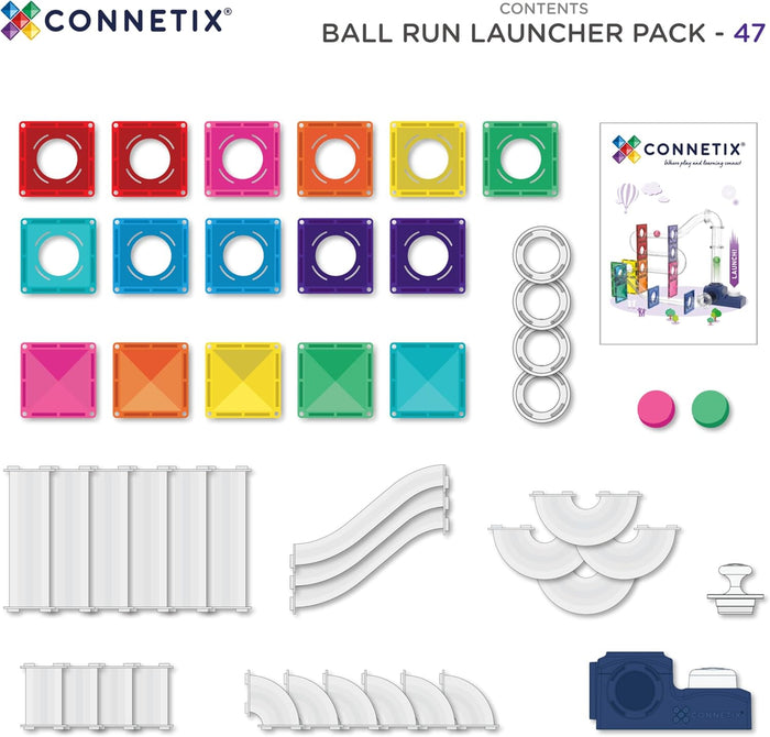 Colorful magnetic tiles, white track pieces, slides, two balls, and a blue launcher unit displayed on white.