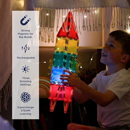 Child holding a glowing rocket built from colorful magnetic tiles, with product feature icons shown on the left.