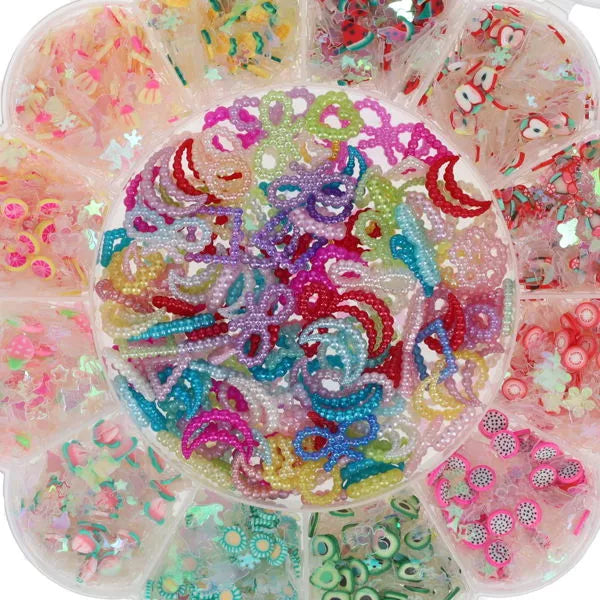 Circular container with various colorful flat-back beads: fruit slices, stars, and pearl-textured moons and bows.