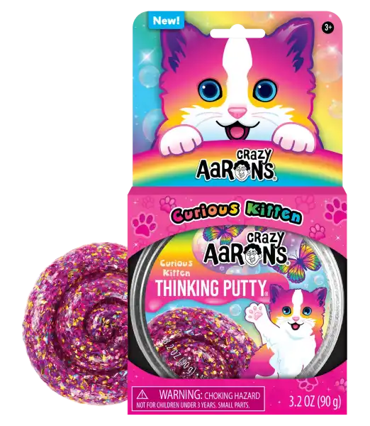 Sparkly purple Thinking Putty swirl next to pink kitten-themed packaging featuring a colorful cartoon cat.