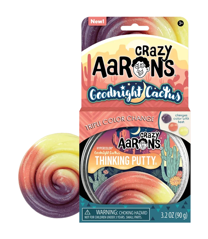 Swirled glittery putty in purple, peach, and yellow next to its desert-themed metal tin and cardboard package.