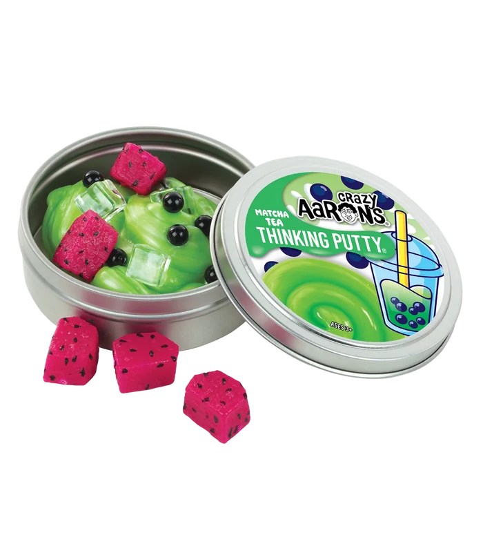 Green matcha thinking putty in a tin with pink dragon fruit cubes, black boba pearls, and clear ice cube charms.