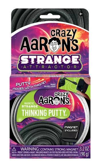 Crazy Aaron's Strange Attractor magnetic thinking putty in a tin with a black magnet and purple galaxy packaging.