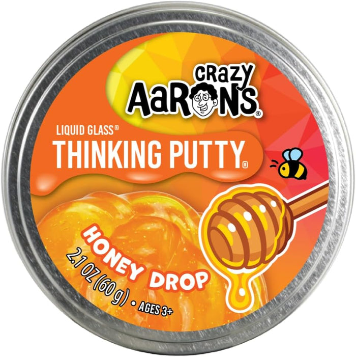 Crazy Aaron's Honey Drop Thinking Putty in a round metal tin with translucent orange putty and a honey dipper illustration.