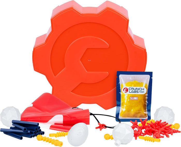 Orange gear case with building parts: blue rods, red connectors, white eggs, a red parachute, and yellow slime pouch.