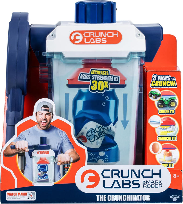 Blue and white toy crusher with clear chamber and blue handle in orange packaging featuring Mark Rober demonstrating.