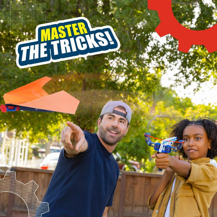 Man points at a flying orange plane while a girl aims a blue launcher. Text reads Master the Tricks!