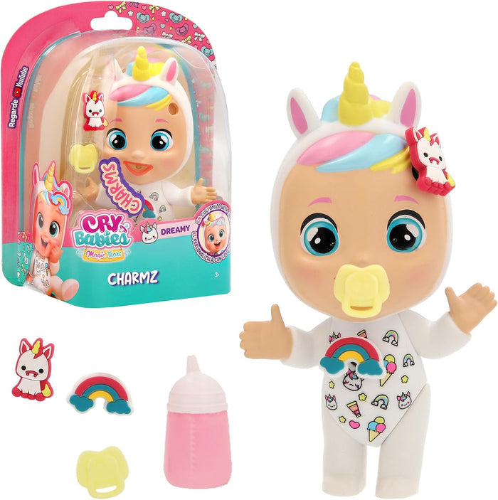Mini doll in white unicorn onesie with pink and blue hair, pink bottle, and charms in pink and teal packaging.