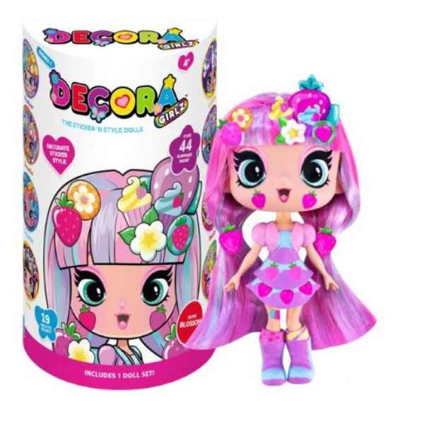 Pink-haired Decora Girlz Blossom doll with strawberry stickers stands next to colorful cylindrical packaging.