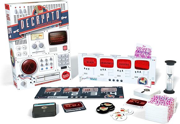 Retro-themed Decrypto board game with white box, screen-style card holder, sand timer, and stacks of cards.