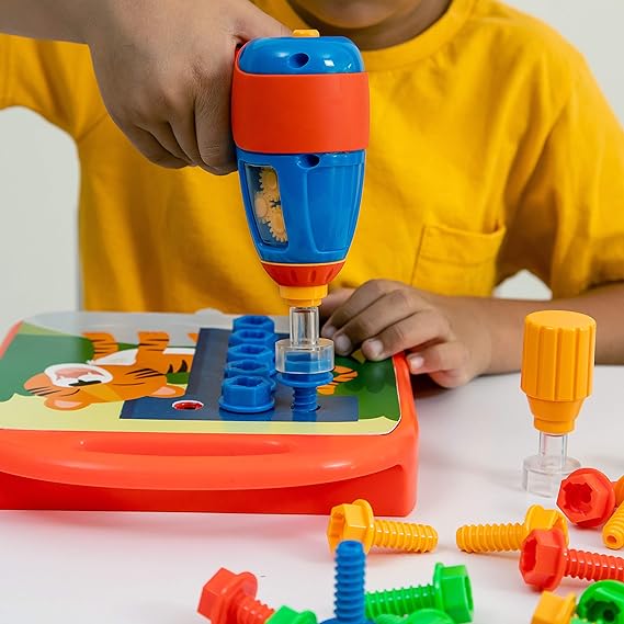 Child using a blue and orange toy drill to screw colorful bolts into a tiger-themed activity board.