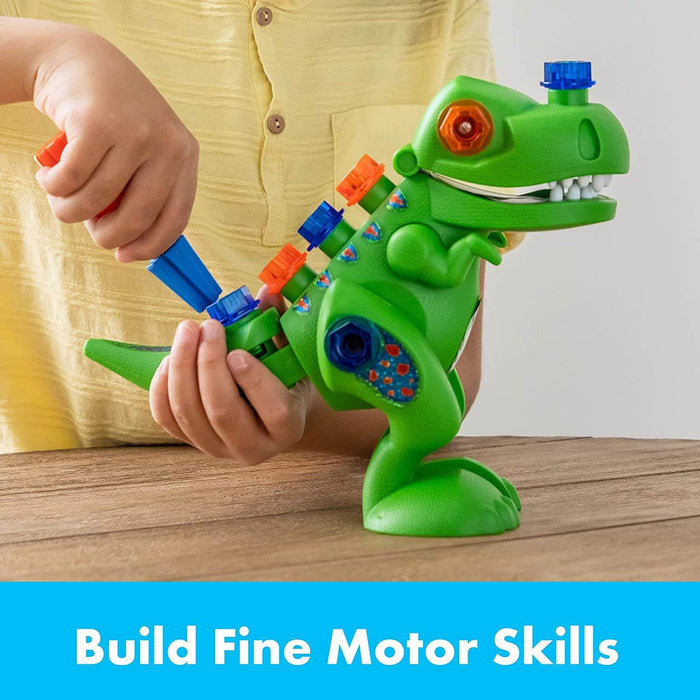 Child using a blue toy screwdriver on a green T-Rex with colorful bolts. Text: Build Fine Motor Skills.